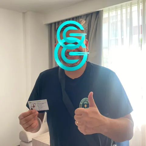 Lucas in Sanur holding the Rupiah cash he received