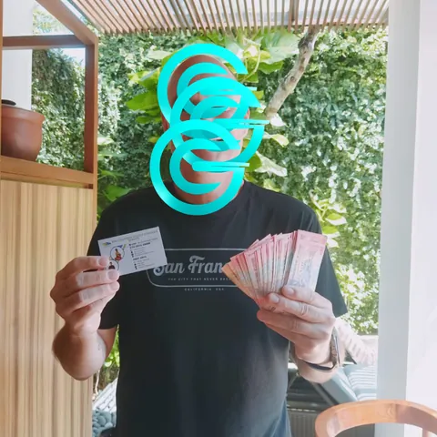 Ryan in Nusa Dua holding the Rupiah cash he received